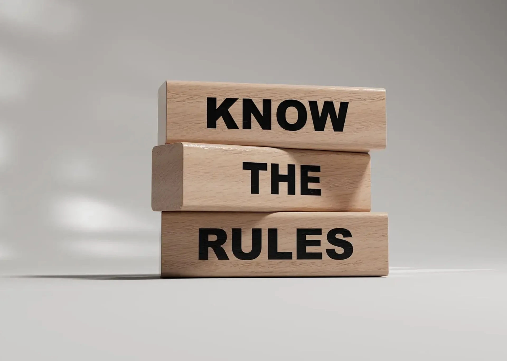 Wooden blocks with "Know the Rules" text.